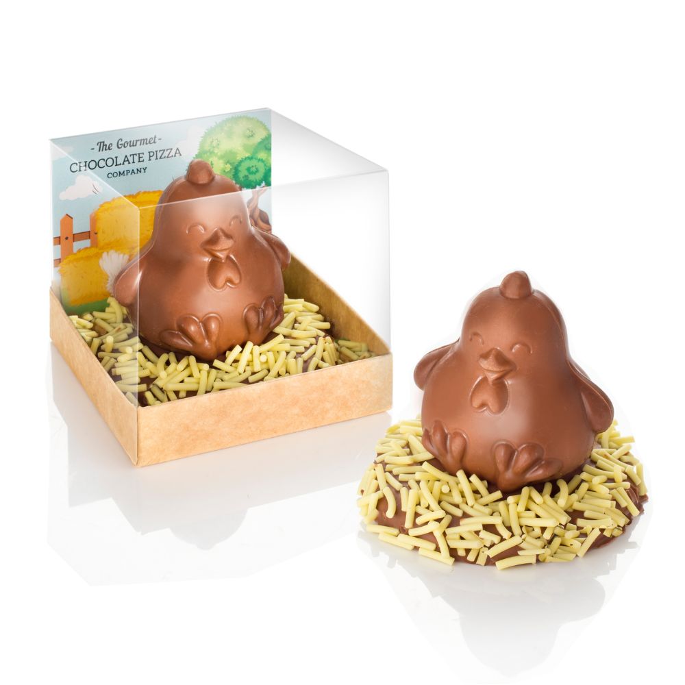 Milk chocolate chick sitting on a chocolate coated biscuit with a yellow sugar strand 'nest.'